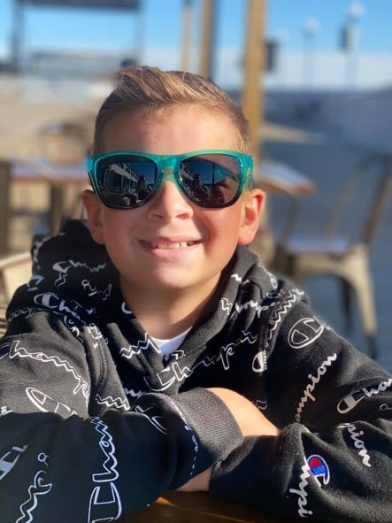 image of smiling blonde child with sunglasses